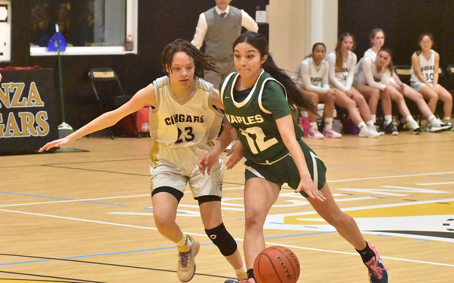 Vicenza’s Trishauna Lewis tries to keep pace as Naples’ Anais Navidad drives toward the basket in the Wildcats’ 34-32 victory Friday, Feb. 2, 2024.