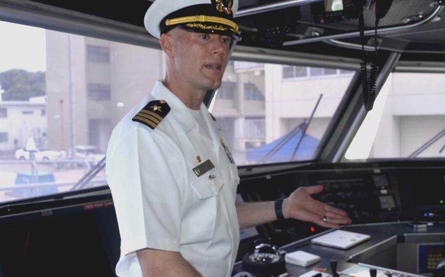 Cmdr. Jeremiah Daley, commander of Unmanned Surface Vessel Division One, discusses the USV Ranger on the ship's bridge at Yokosuka Naval Base, Japan, on Sept. 21, 2023. 