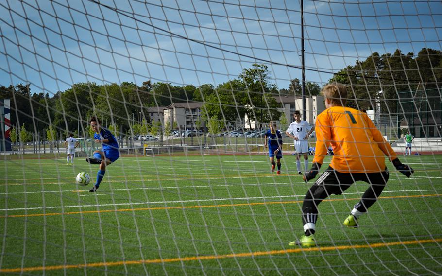 Wiesbaden Warrior Noah Lee sinks a penalty goal against SHAPEs goalie Krystian Pikul during the DODEA-Europe Soccer Championships at Ramstein Air Base, Germany, May 16, 2022. The tough fight during pool play yielded penalty cards and kicks as players of both teams attempted to break a stalemate that lasted much of the first half of the game.