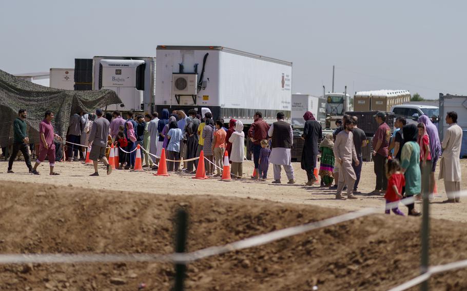 Afghan refugees line up for food outside a dining hall at Fort Bliss’ Doña Ana Village where they are being housed in Chaparral, N.M., Friday, Sept. 10, 2021. 