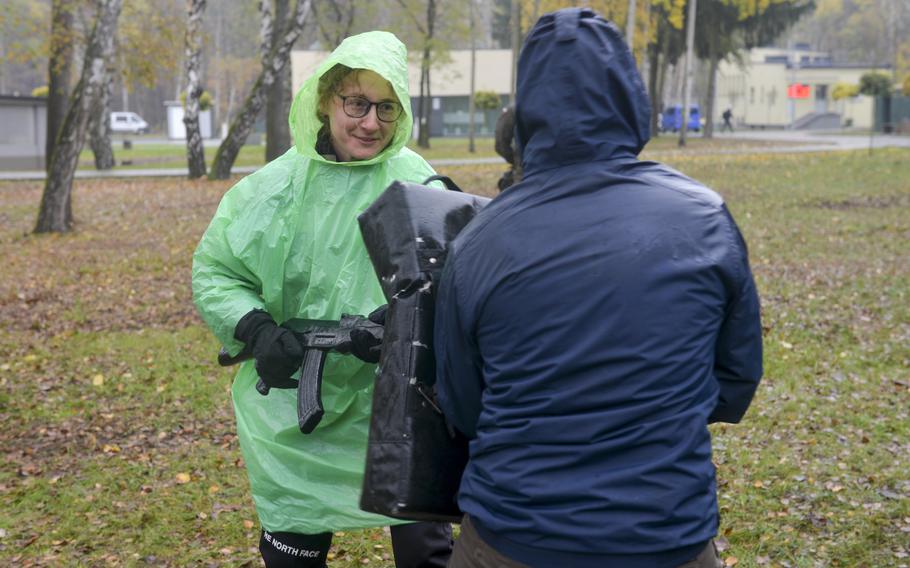 Danuta, a Polish woman who lives in England and who declined to provide her last name, jabs her training rifle at an instructor while learning self-defense at a course at the Military University of Technology in Warsaw, Poland, on Nov. 5, 2022.