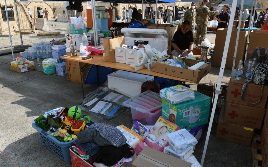 Boxes of donations collected for Afghan evacuees can be seen inside the tent city set up for evacuees at Ramstein Air Base, Germany, Aug. 21, 2021. Most evacuees came with few belongings and community members have collected diapers, toys, clothing and other items for families in need.