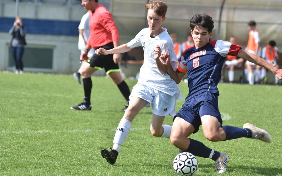 Aviano’s Xavier Fox gets the ball away before Vicenza’s Collin Frazee can get to it Saturday, April 23, 2023, in the Cougars’ 6-3 victory.
