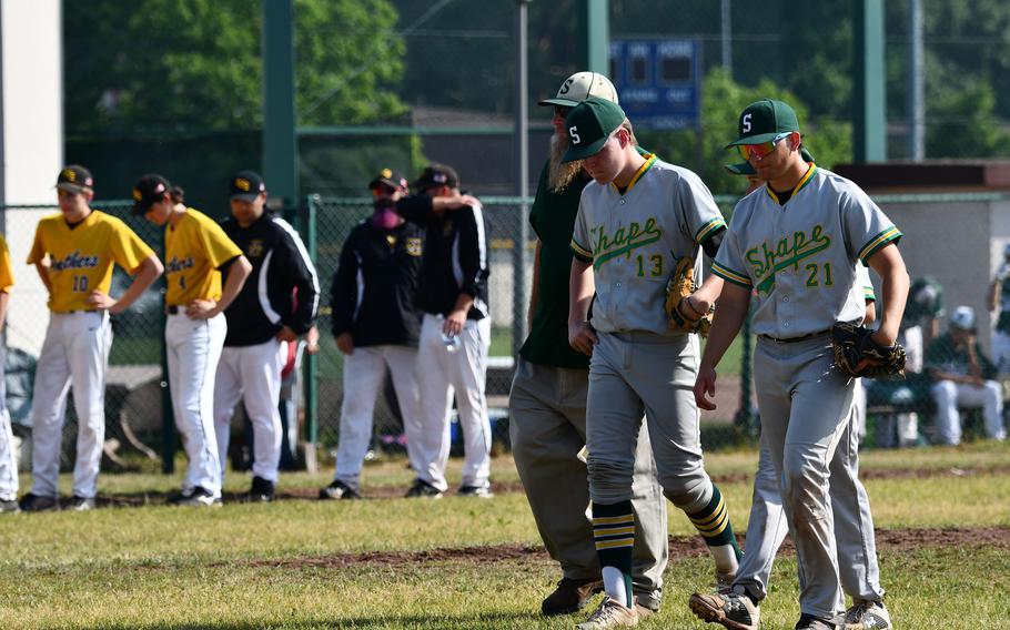 SHAPE  head coach Scott Burgess walks his players off the field after a tough loss Friday, May 20, 2022, in the elimination round against the Stuttgart Panthers at the 2022 DODEA-Europe baseball championships.