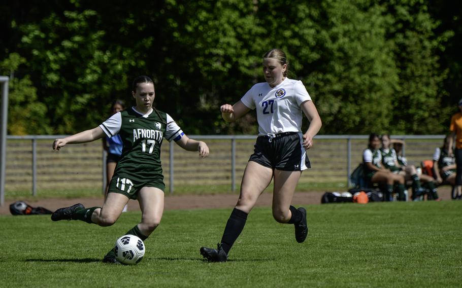 Isabella Guest of AFNORTH pushes past Brussels' Taegan Muller during the 2024 DODEA European Soccer Division III Championships in Landstuhl, Germany, on May 20, 2024. AFNORTH won the game 5-0.