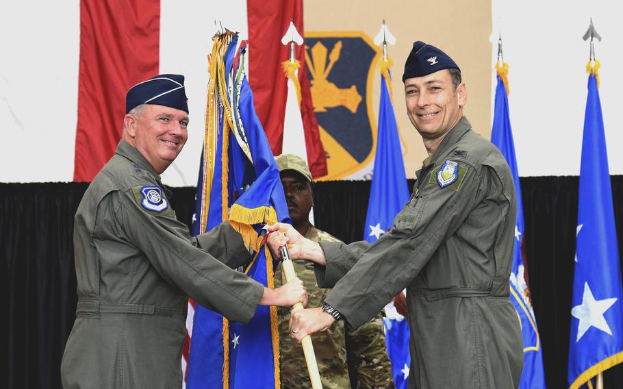 Incoming commander Col. Andrew L. Roddan receives the 374th Airlift Wing guidon from Lt. Gen. Ricky N. Rupp, commander, U.S. Forces Japan and 5th Air Forces, during a change-of-command ceremony at Yokota Air Base, Japan, June 23, 2022. 