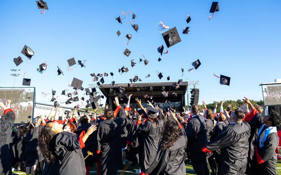 Graduates in Kaiserslautern High School’s Class of 2022 toss their graduation caps in the air at the end of the school’s commencement ceremony on Wednesday, June 1, 2022, at Raider Stadium in Kaiserslautern, Germany.