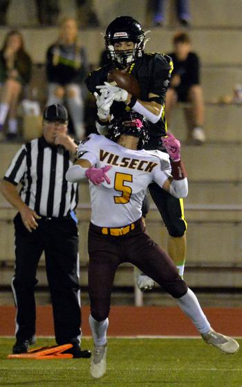 Stuttgart’s Jace Holmes pulls in a pass over Vilseck’s Junior Gonzalez in the Panthers’ 51-12 win over the Falcons in the DODEA-Europe Division I football championship game at Kaiserslautern, Germany, Oct. 29, 2022.