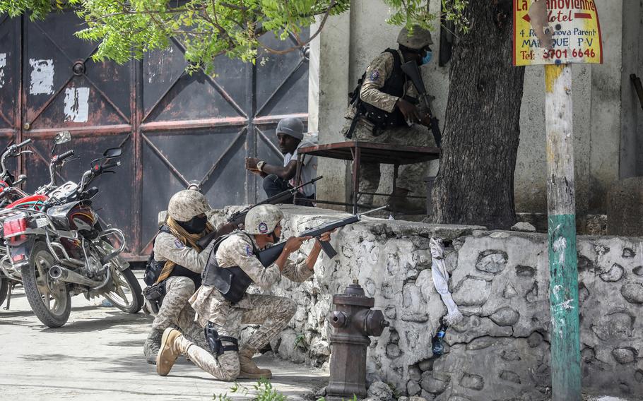 Police exchange fire with armed men next to the Petionville police station in Port-au-Prince on July 8, 2021. 