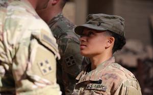 Lt. Col. Gregory Polk, the 299th Bridge Engineer Battalion commander, speaks to a soldier after pinning on the Combat Action Badge during a ceremony at Union III forward operating base in Baghdad, March 24, 2022. The soldiers were awarded for their response to an enemy attack that occurred days after the U.S.-led coalition transitioned to an advisory mission late last year.