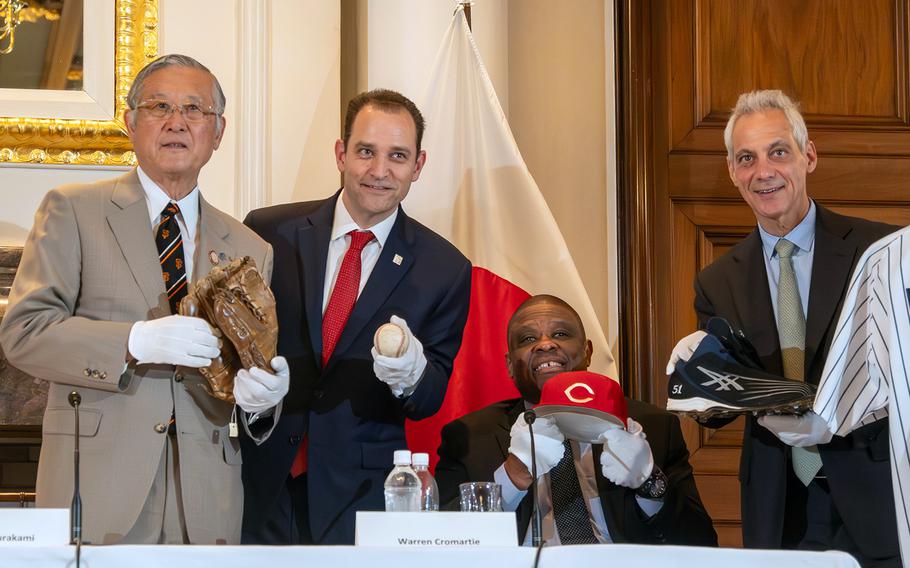 Baseball memorabilia is shown off by, from left, San Francisco Giants pitcher Masanori Murakami; National Baseball Hall of Fame and Museum president Josh Rawitch; former Yomiuri Giants slugger Warren Cromartie; and U.S. Ambassador to Japan Rahm Emanuel at the ambassador's residence in Tokyo, April 18, 2024.