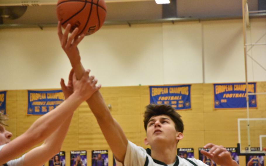 AFNORTH’s Nathan Goldsmith grabs a rebound despite someone grabbing his arm in a Division III semifinal at the DODEA European Basketball Championships in Wiesbaden, Germany, on Friday, Feb. 16, 2024.