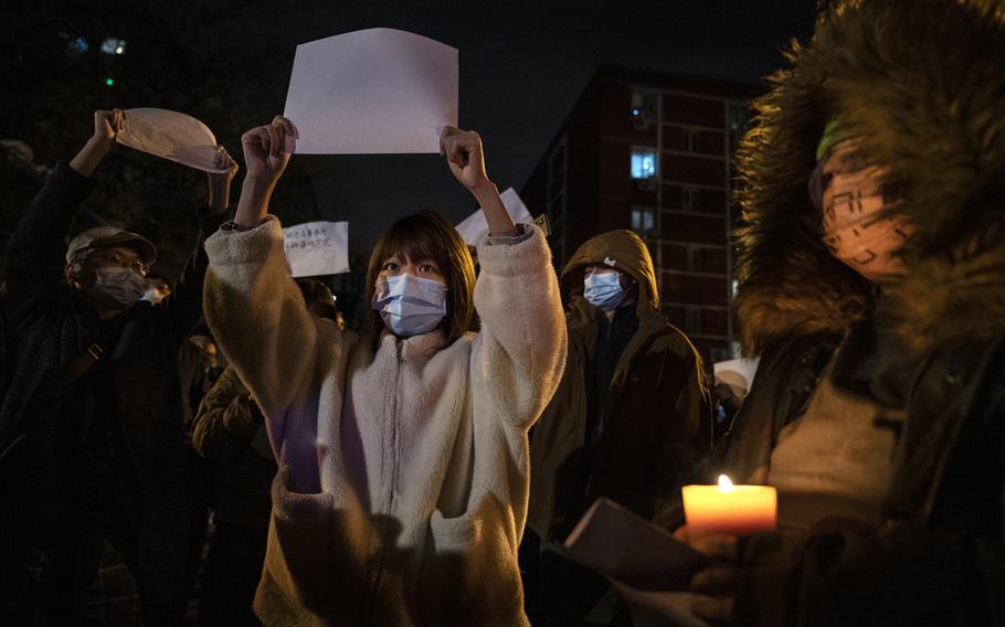 Protesters hold up a white piece of paper against censorship as they march during a protest against Chinas strict zero COVID measures on Nov. 27, 2022, in Beijing. First-time protesters in China grapple with how much agency they can wrest from an authoritarian government after the largest demonstrations since 1989.