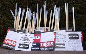 FILE - Placards are gathered together at the close of a picket by members of The Writers Guild of America outside Walt Disney Studios, Tuesday, May 2, 2023, in Burbank, Calif. On Sunday, Sept. 24, 2023, a tentative deal was reached to end Hollywood’s writers strike after nearly five months. (AP Photo/Chris Pizzello, File)