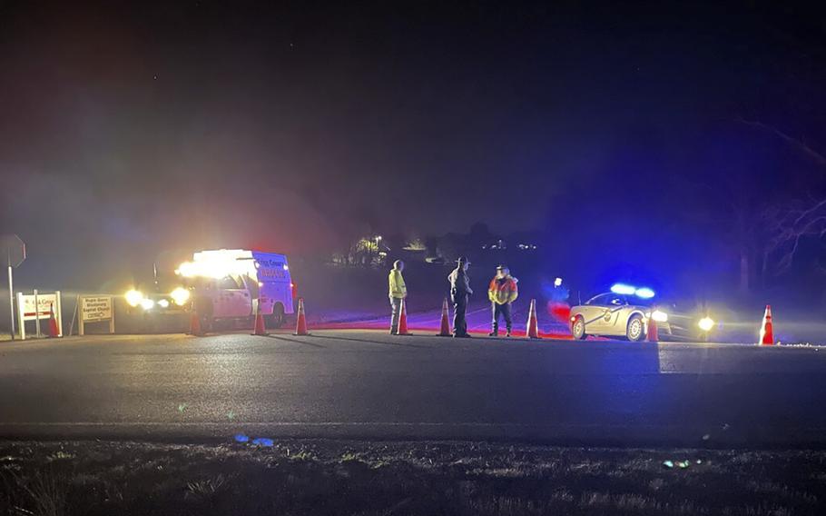 Emergency responders are seen near a site where two military helicopters crashed during a routine training mission in Trigg County, in southwestern Kentucky, on March 30, 2023. The helicopters collided in midair during a nighttime training flight before they went down in a field in Kentucky on March 29, killing nine soldiers, Army investigators said in a preliminary report. 