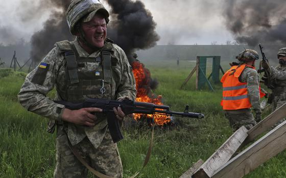 In this photo provided by Ukraine's 65th Mechanized Brigade press service, Ukrainian servicemen attend a military training in Zaporizhzhia region, Ukraine, Monday, May 26, 2025. (Andriy Andriyenko/Ukraine's 65th Mechanized Brigade via AP)