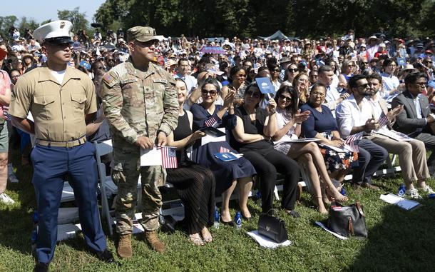 A Marine and an Army service member stand in recognition.
