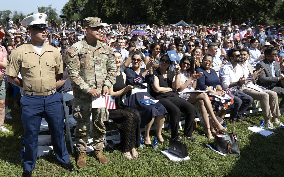 A Marine and an Army service member stand in recognition.