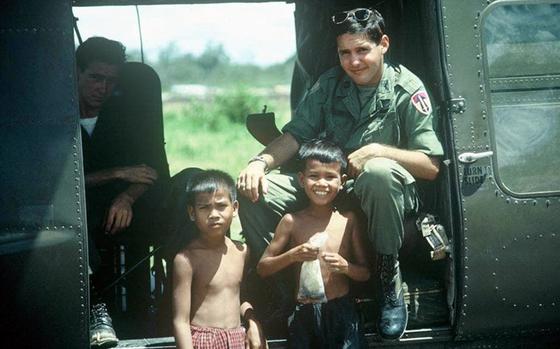Larry Liss in 1966, sitting in a Huey helicopter with two orphans in South Vietnam. During the Vietnam War, Liss flew more than 650 combat missions. One of those missions resulted in Liss and co-pilot Tom Baca rescuing 87 friendly forces from a surrounding North Vietnamese force of about 650 fighters.