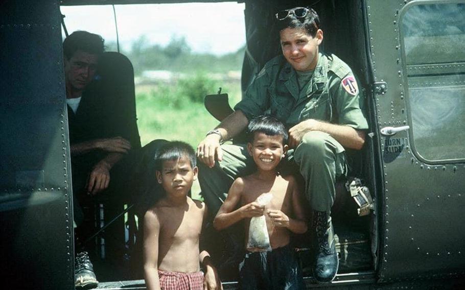 Larry Liss in 1966, sitting in a Huey helicopter with two orphans in South Vietnam. During the Vietnam War, Liss flew more than 650 combat missions. One of those missions resulted in Liss and co-pilot Tom Baca rescuing 87 friendly forces from a surrounding North Vietnamese force of about 650 fighters.