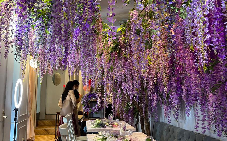 The interior of the Haute Couture Cafe in Aobadai, Tokyo, was trimmed in purple wisteria on June 8, 2022. 