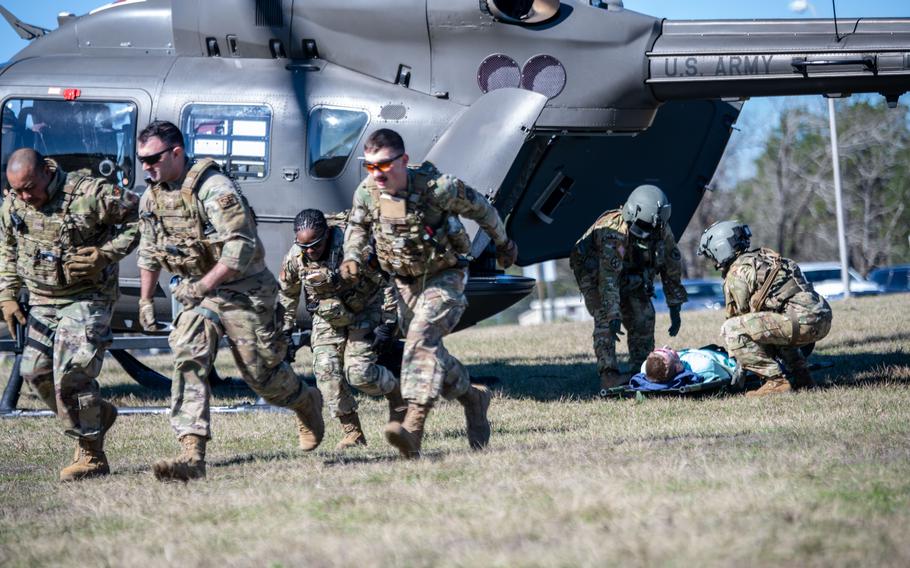 Air National Guard Security Forces airmen deliver an injured role-play victim to a UH-72 Lakota helicopter for transport during a PATRIOT 24 search and rescue exercise, Camp Shelby, Miss., Monday, Feb. 19, 2024.