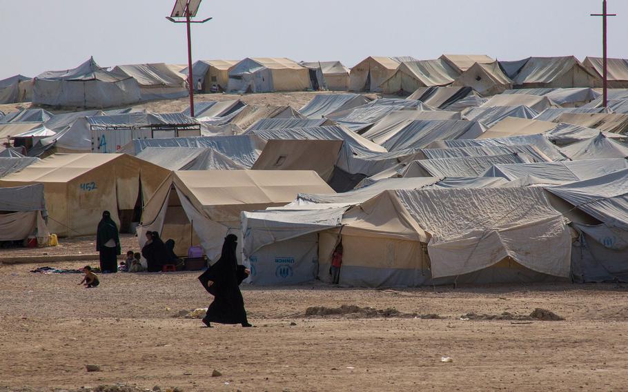 A woman walks inside the al-Hol refugee camp in northern Syria, Oct. 17, 2019.