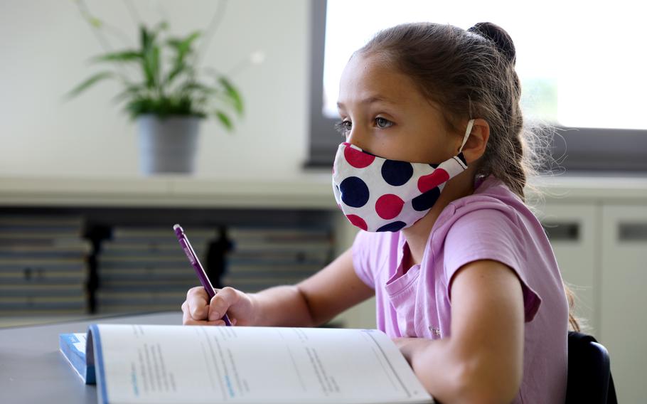 A student at Vogelweh Elementary School in Kaiserslautern, Germany, pays attention during a lesson in September 2020. Defense Department schools in Europe are scaling back COVID-19 notifications and contact tracing, but face masks in schools will continue to be required for now.