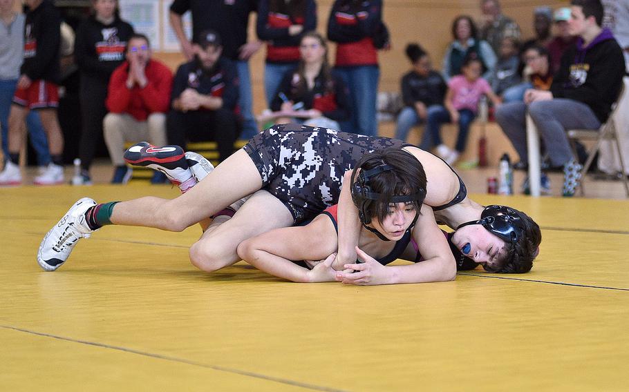 Kaiserslautern's Uno Tate tries to break out of the grasp of Stuttgart's Dominick Welsh in a 113-pound semifinal match during a DODEA wrestling sectional meet on Feb. 3, 2024, at Stuttgart High School in Stuttgart, Germany.