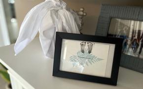 Air Force Reserve officer Bari Wald and her Marine husband keep their lost son's inked footprints in a frame on the fireplace mantel next to an urn wrapped in white containing his ashes. Weighing less than 13 ounces when he was born by induced labor because of severe fetal anomalies, he is never forgotten, Wald said.