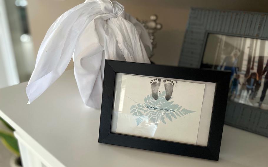 Air Force Reserve officer Bari Wald and her Marine husband keep their lost son's inked footprints in a frame on the fireplace mantel next to an urn wrapped in white containing his ashes. Weighing less than 13 ounces when he was born by induced labor because of severe fetal anomalies, he is never forgotten, Wald said.