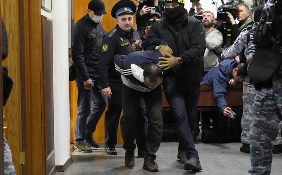Saidakrami Murodali Rachabalizoda, a suspect in the Crocus City Hall shooting, is escorted by police and FSB officers to the Basmanny District Court in Moscow on March 24, 2024.