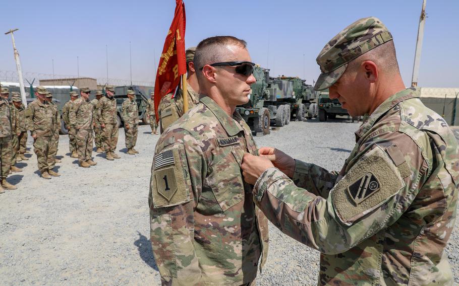 Army Staff Sgt. Austin Nunnally receives his newly earned rank patch from Capt. Nathan Davis at Camp Arifjan, Kuwait, in 2021. Promotion points for sergeant and staff sergeant now reward soldiers more for military education and individual awards while placing less emphasis on physical fitness.