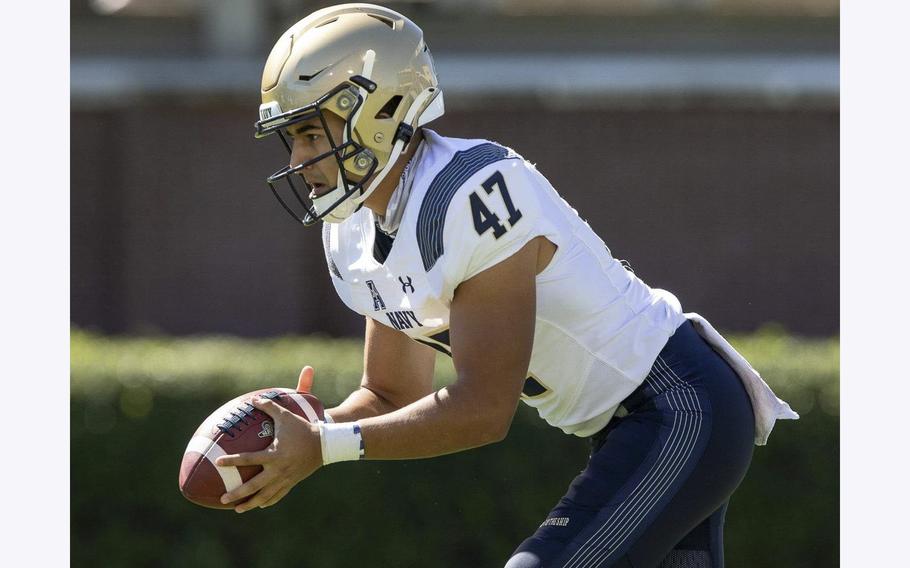 Daniel Davies prepares to punt for the Navy Midshipmen.