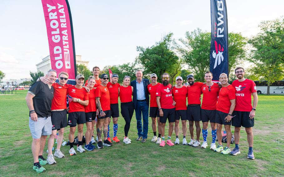 Secretary of the VA Doug Collins poses for a photo with runners