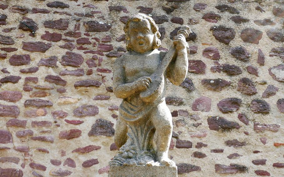 This little musician tops a fountain in what was the moat surrounding Burg Hayn, Dreieichenhain, Germany’s medieval castle.