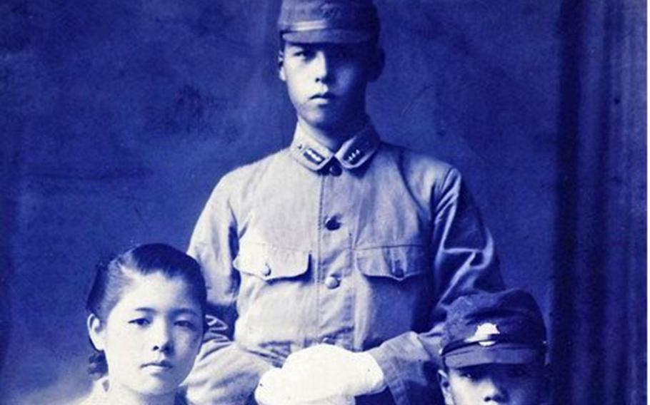 Morihiro Murota, center, standing, poses with his younger sister, Mitsuko, left, prior to shipping out to Iwo Jima during World War II.