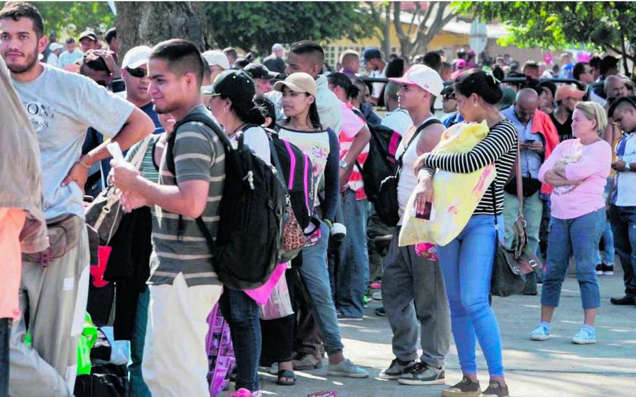 Venezuelan migrants wait in line to get their passport stamped at the Immigration office in Cucuta, Colombia.