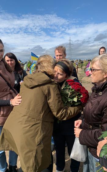 Bonnie Carroll, who since 2014 has helped with services for devastated survivors of war in Ukraine, hugs Zinaida Voronova, a woman who lost her two sons in war initiated by Russia, at her last surviving son’s funeral in Dnipro in September 2022.