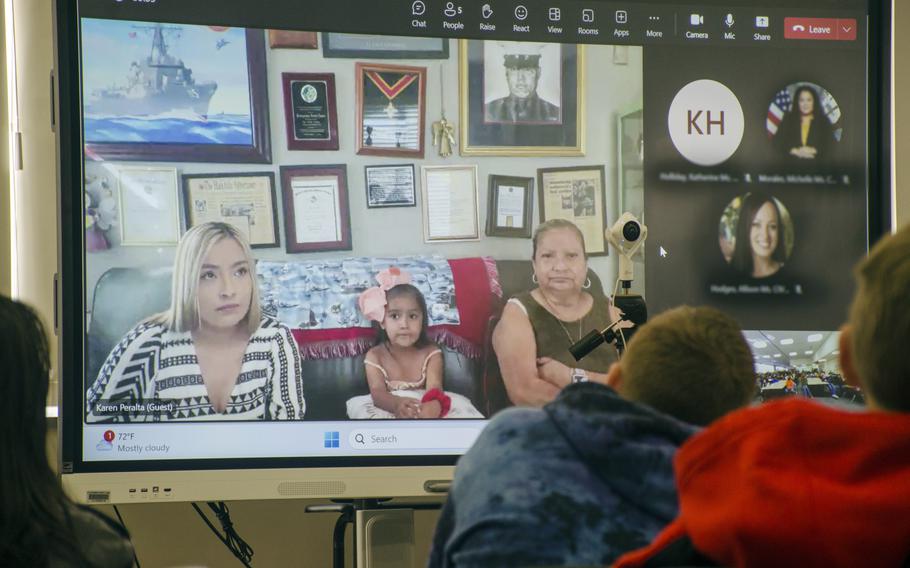 Students speak with the family of the USS Rafael Peralta's namesake during a video meeting at the middle school at Yokosuka Naval Base, Japan, Wednesday, Oct. 11, 2023.