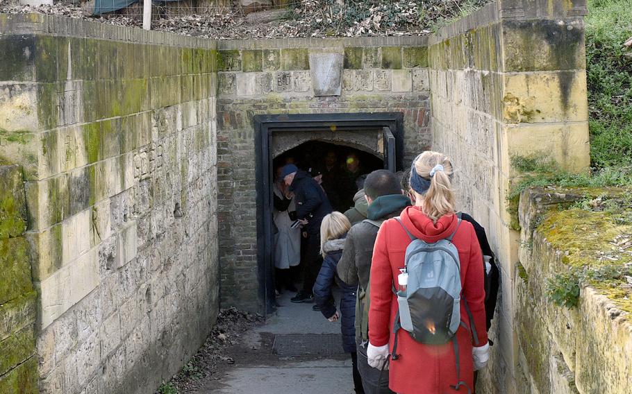 People wait outside the entrance of the Noord Grotten, or North Caves, for a tour in Maastricht, Netherlands, on Feb. 27, 2023.