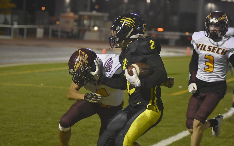 Vilseck's Zephanyah Barnes tries to prevent a Stuttgart touchdown in the DODEA-Europe Division I title game, but Stuttgart's Tyler Farrar keeps him away with a stiff arm. The Panthers prevailed 57-14 on Saturday, Oct. 30, 2021.