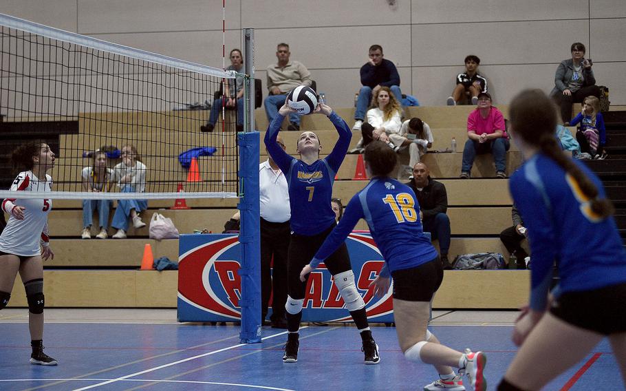 Wiesbaden's Audrey Garrison sets the ball while teammate Hannah Buchheit runs toward the net during a Division I semifinal at the DODEA European volleyball championships on Oct. 27, 2023, at Ramstein High School on Ramstein Air Base, Germany.