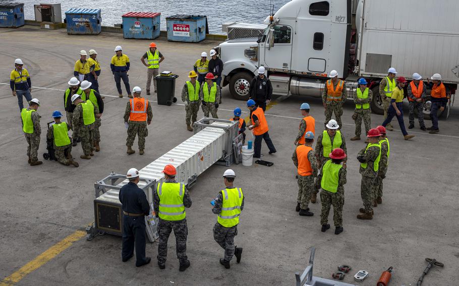 U.S. and Australian sailors and contractors inspect and prep an SM-2 missile to be loaded aboard the USS Rafael Peralta in Eden, Australia, Aug. 22, 2023. 