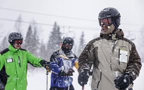 Joshua Crowther, 20, right, and Enrique Montes, 25, of the U.S. Army receive their first ski lessons from instructor Ron Oscarson, left, at a retreat at Whitefish Mountain Resort in Whitefish, Mont., on Jan.11, 2022. (Hunter D'Antuono/Flathead Beacon via AP)