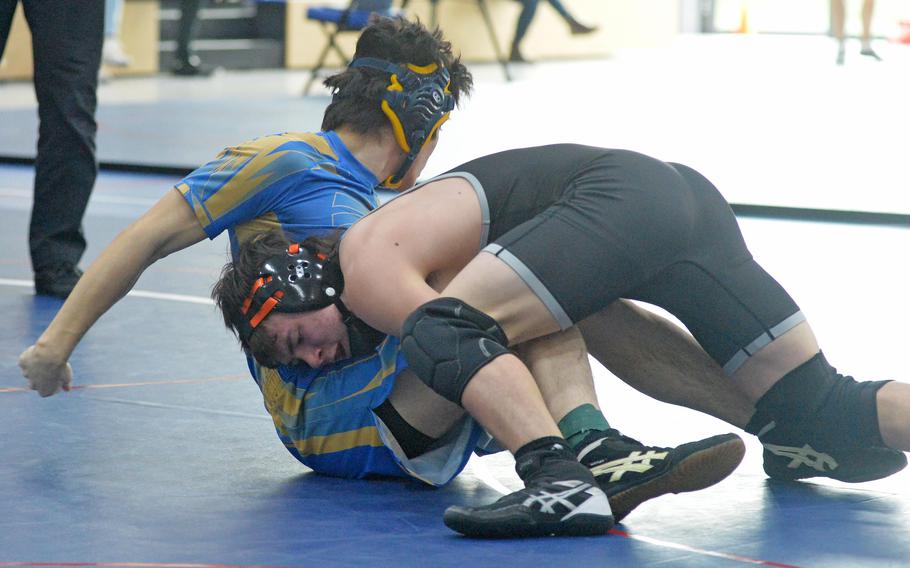Wiesbaden’s Justin Harder, left, tries to get out of the grip of SHAPE’s Brendan Castillo in a 132-pound match at the high school 2022 Wrestling Tournament in Ramstein, Germany, Feb. 11, 2022. Castillo went on to win the match.