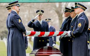 A soldier of the Old Guard salutes as the flag is removed from the coffin of Gen. Montgomery C. Meigs at Arlington National Cemetery, Jan. 25, 2022. Meigs, the former commander of U.S. Army Europe, died July 6, 2021.