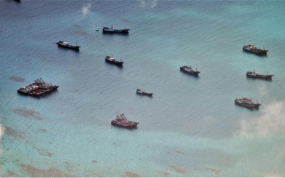 Chinese vessels gather in disputed waters west of Palawan province, in this photo posted by the Philippine armed forces, Saturday, July 8, 2023. 
