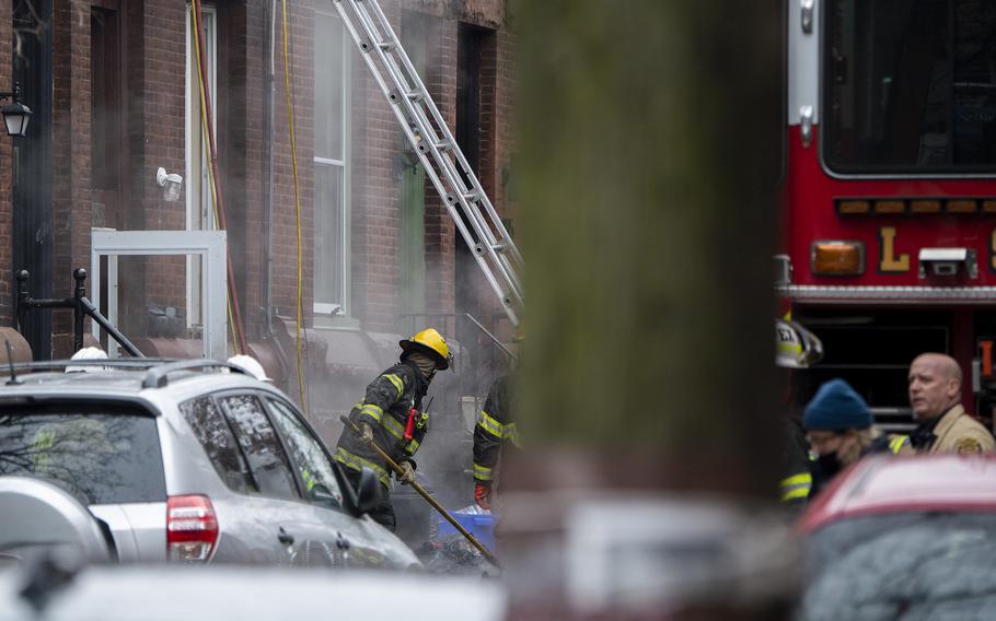 Fire crews work at the scene of a fatal fire in Philadelphia,  on Wednesday, Jan. 5, 2022. 