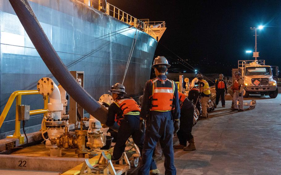 Workers supporting Joint Task Force-Red Hill transfer fuel to a merchant tanker at Joint Base Pearl Harbor-Hickam, Hawaii, on Oct. 19, 2023. 